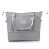 A gray duffel bag with two handles and a logo on the front. Produktbild-Vorschau