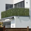 A balcony with a privacy screen made of artificial leaves attached to the railing. Anteprima dell’immagine prodotto