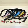 A collection of colorful headphones laid out on a wooden surface. Produktbild-Vorschau