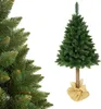 A close-up of a Christmas tree on the left and a full shot of a Christmas tree on a stand on the right, both on a white background. Podgląd zdjęcia produktu