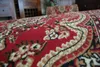 A close-up view of a red carpet with a traditional pattern. Produktbild-Vorschau