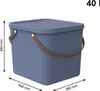 A blue storage bin with brown handles is shown from a slightly elevated side angle. Dimensions are indicated with lines and text. Produktbild-Vorschau