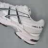 A close-up side view of a white and black ASICS sneaker against a light gray background. Produktbild-Vorschau
