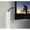 A white PVC cable management channel is shown attached to a wall next to a television displaying a silhouette of a cyclist. Produktbild-Vorschau