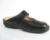 A black leather clog shoe is shown from the side against a white background. Podgląd zdjęcia produktu