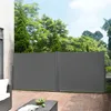 A patio with wooden flooring, featuring a grey retractable side awning, a sofa, and a coffee table with fruit. Náhled obrázku produktu