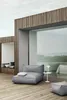 A modern outdoor lounge area with a large window overlooking the sea. Podgląd zdjęcia produktu