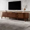 A modern wooden TV stand with a TV mounted above it, in a living room setting. Podgląd zdjęcia produktu
