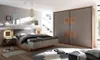 A modern bedroom with a bed, nightstands, and a large wardrobe. Produktbild-Vorschau