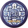 A round tin with a blue and white tile pattern and a yellow banner with text. Náhľad obrázku produktu
