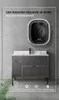 A wall-mounted washing machine above a vanity in a bathroom setting. Anteprima dell’immagine prodotto