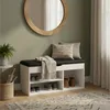 A shoe cabinet with a bench seat in a hallway, next to a mirror and a plant. Náhľad obrázku produktu