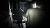 Two people walking up a dark, dilapidated staircase. Produktbild-Vorschau