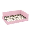 A pink upholstered bed frame with wooden slats, viewed from a diagonal angle. Náhled obrázku produktu