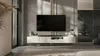 A modern living room with a wall-mounted TV cabinet and a large television. Produktbild-Vorschau
