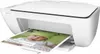 A white HP Deskjet 2130 printer is shown with a printed page emerging from the output tray. The printed page features a close-up of a baby wearing a green frog-themed hat. Produktbild-Vorschau