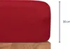 A close-up view of a red fitted sheet, showing its depth and texture, with a measurement indicator. Produktbild-Vorschau