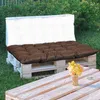 Outdoor seating area with pallet furniture and cushions. Anteprima dell’immagine prodotto