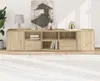 A long, low entertainment center with multiple compartments and drawers, set against a white wall with a rug in the foreground. Podgląd zdjęcia produktu