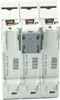 A close-up, straight-on view of three white circuit breakers stacked vertically, with a gray locking mechanism in the center. Produktbild-Vorschau