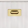 A close-up shot of a gold handle on a white, ribbed surface. Anteprima dell’immagine prodotto