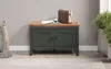 A dark green storage bench with a wooden top sits against a light gray wall, with a basket of blankets to the left and a potted plant to the right. Anteprima dell’immagine prodotto