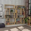A modern wooden bookshelf filled with books and decorative items, set against a textured gray wall. Podgląd zdjęcia produktu
