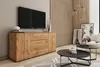 A modern living room with a TV, a wooden sideboard, coffee tables, and artwork.