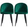 Two green velvet dining chairs with black metal legs are shown against a white background.