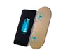 A smartphone is shown next to a gold-colored wireless charging pad. The smartphone screen displays a battery charging icon. Produktbild-Vorschau