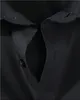 A close-up view of the collar and button placket of a black shirt. Produktbild-Vorschau