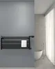 A modern bathroom with a black towel warmer mounted on a gray wall. Produktbild-Vorschau