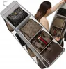 A woman is organizing handbags in a hanging closet organizer. Produktbild-Vorschau