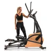 A woman stands next to an elliptical trainer. Podgląd zdjęcia produktu