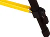 A close-up view of a joint mechanism on a tripod or stand, showing a yellow metal bar connected to a black leg with a black plastic clamp. Podgląd zdjęcia produktu