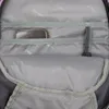 Inside view of a backpack compartment showing pockets and a phone. Voir les images du produit