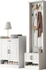 A white entryway furniture set including a tall coat rack with hooks and a bench with storage, and a separate shoe cabinet with doors and shelves. Produktbild-Vorschau