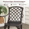 A close-up of a dark brown aluminum garden chair with a lattice back, placed on a wooden deck next to a potted plant. Podgląd zdjęcia produktu