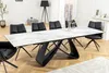 A modern dining room with a large extendable dining table and chairs. Produktbild-Vorschau