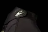 A close-up shot of the collar of a black wetsuit with a logo. Produktbild-Vorschau