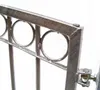 A close-up view of a metal gate hinge and decorative circles. Produktbild-Vorschau
