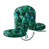 A close-up studio shot of a green and black tropical leaf patterned chair cushion set. Produktbild-Vorschau