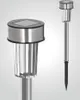 Two silver LED solar garden stakes against a light gray background. One stake is shown close-up, highlighting its solar panel and textured glass shade. The other stake is shown full-length, demonstrating its stake base. Produktbild-Vorschau