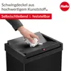 A hand is shown wiping the lid of a black trash can. Náhled obrázku produktu