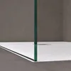 A close-up view of a modern shower enclosure with a glass panel and a white shower tray. Voir les images du produit