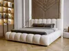 A modern bedroom with a large, upholstered bed as the focal point. Produktbild-Vorschau