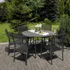 A round outdoor dining table with six chairs set up on a paved patio surrounded by lush greenery. Produktbild-Vorschau