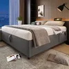 A modern bedroom scene with a bed, nightstand, and window view. Náhled obrázku produktu