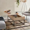 A modern living room scene featuring a lift-top coffee table with drinks and snacks. Produktbild-Vorschau