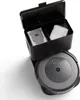 A robotic vacuum cleaner docked in its charging station, with the lid open to reveal dust bags. Voir les images du produit